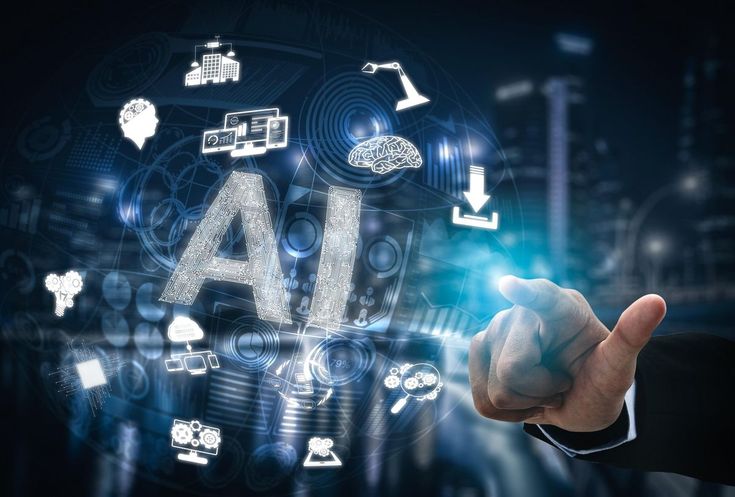 A human hand in a dark suit pointing toward a luminous, futuristic digital sphere. At the center of the sphere are the letters "AI" patterned like a circuit board, surrounded by glowing technological icons such as a brain, gears, cloud computing, and data charts, all set against a dark, blurred background.